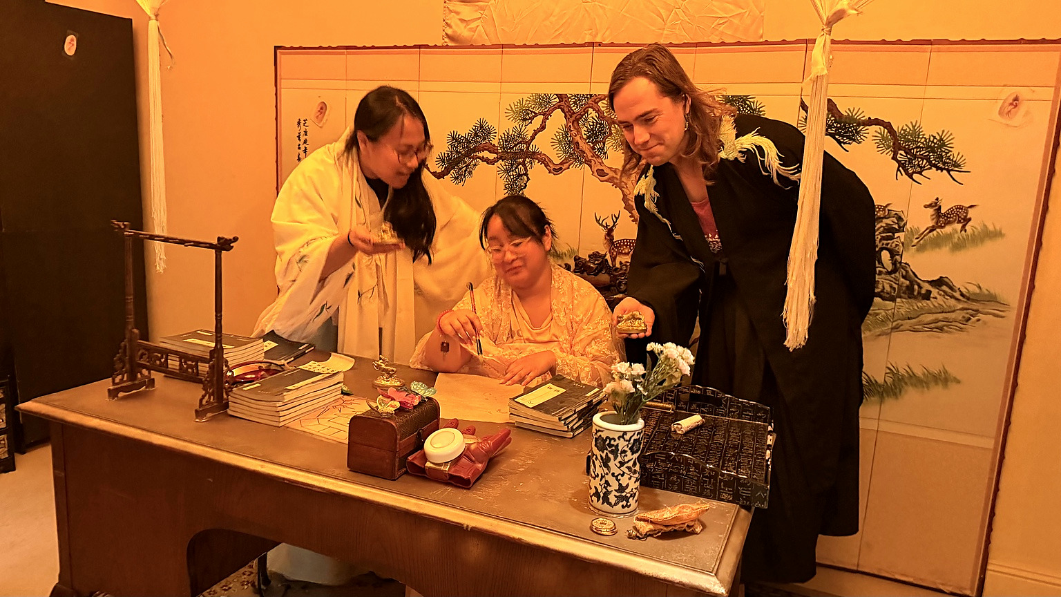 Royal Library players examining objects at the desk