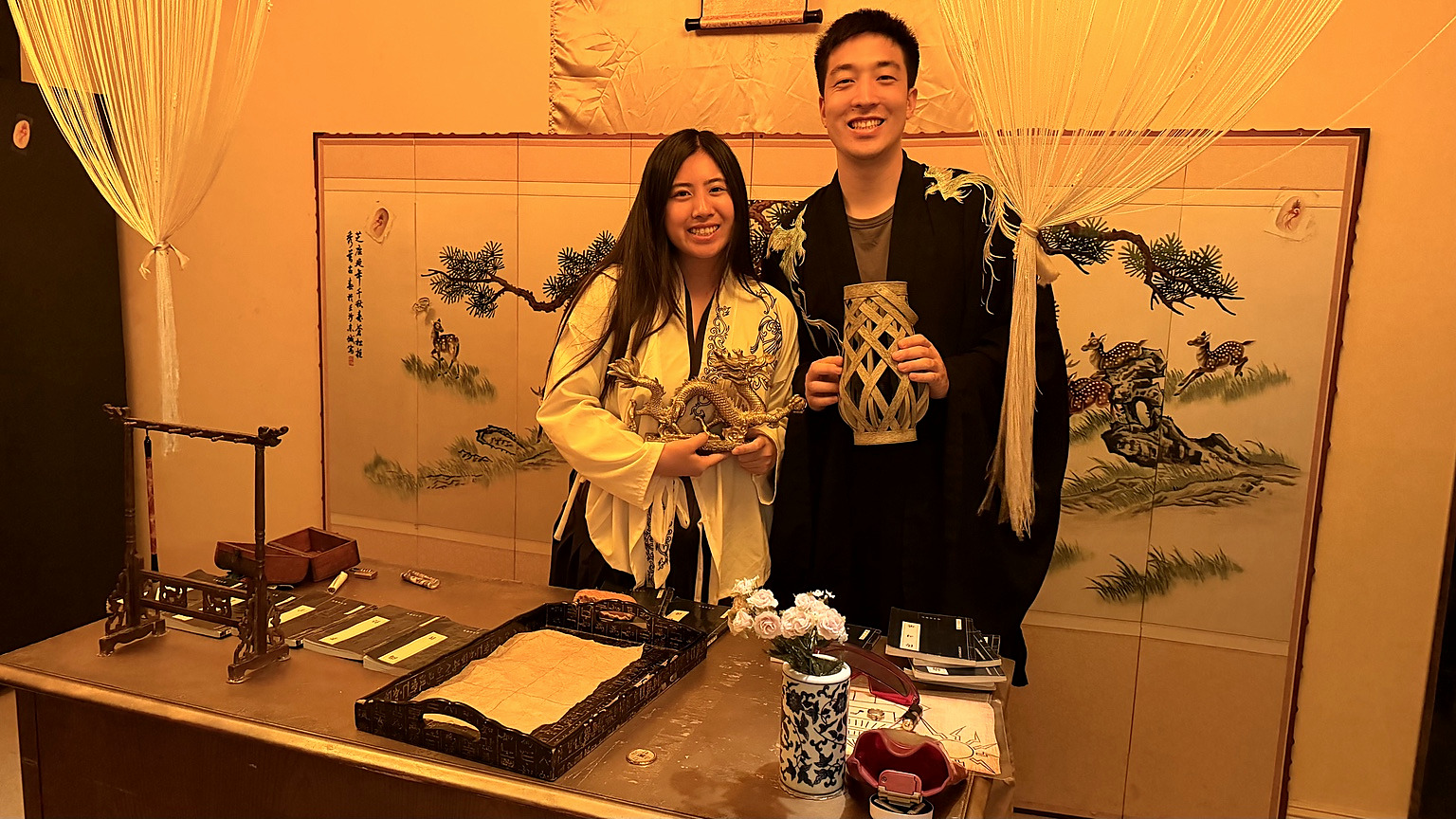 Two Royal Library players in gold and black costumes