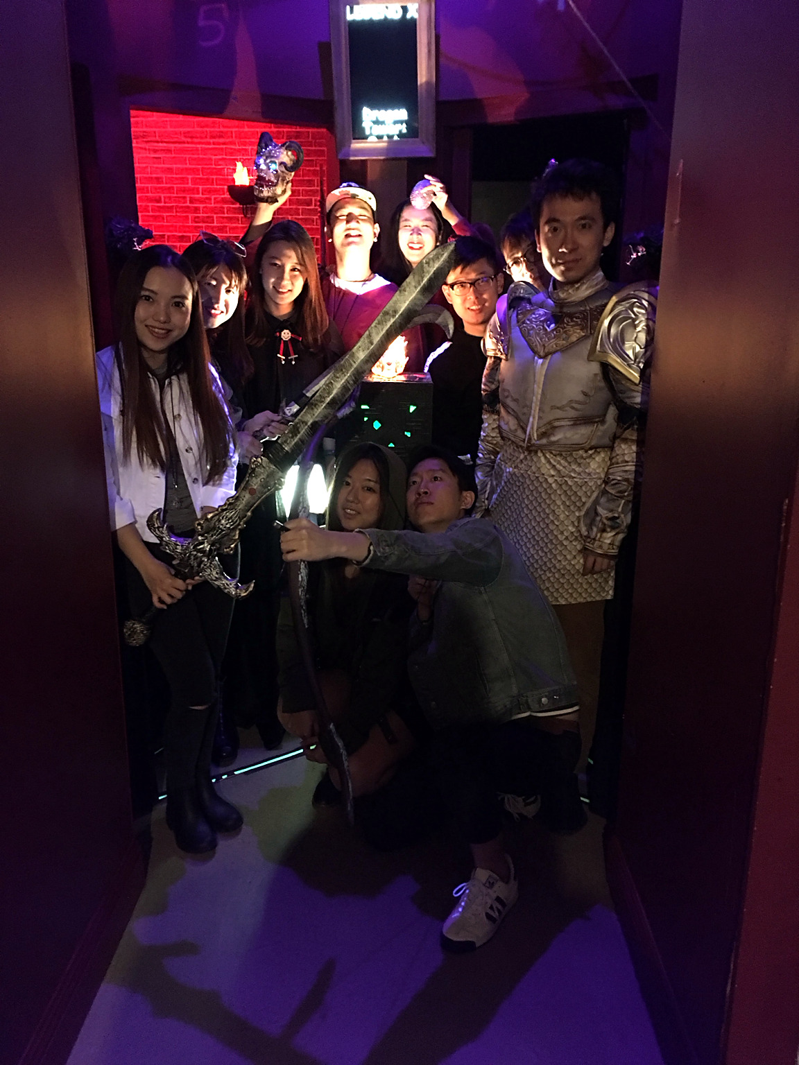 Dragon Tower players posing with a giant sword