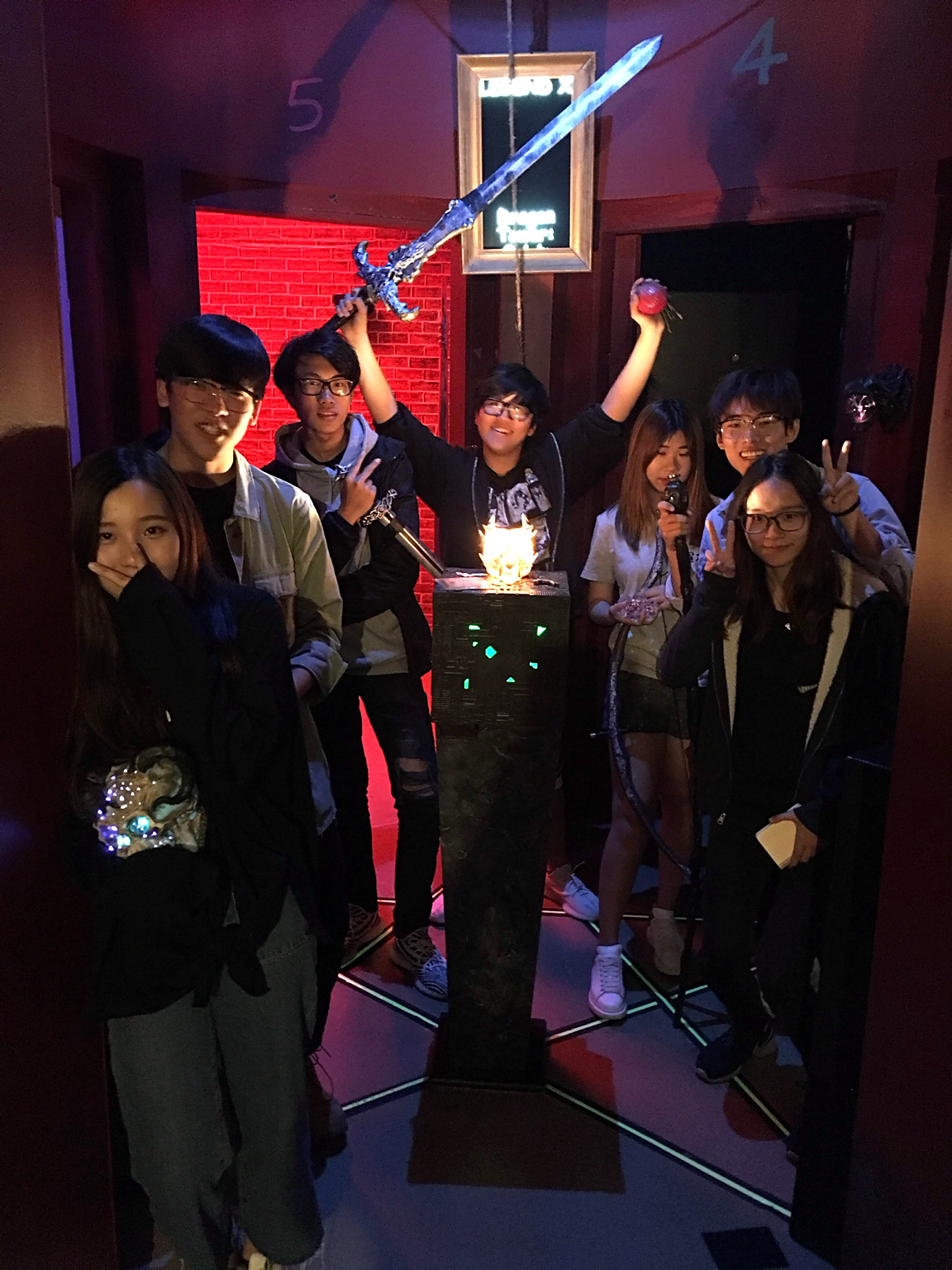 A lively Dragon Tower group raising a sword and props