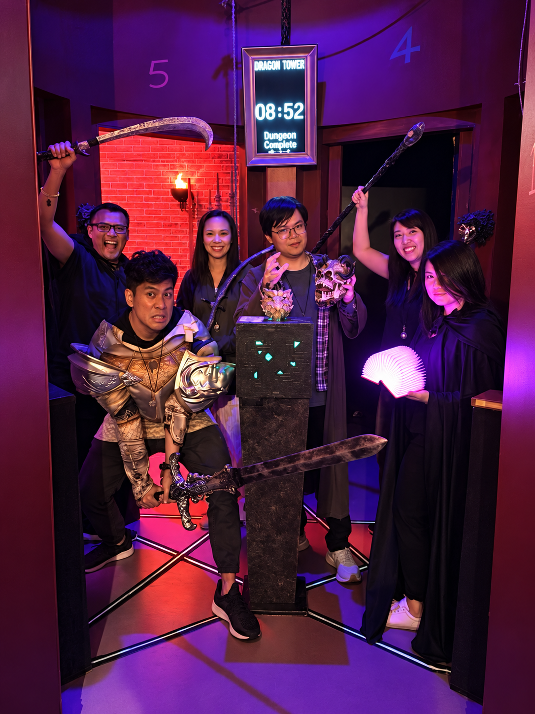 Dragon Tower players celebrating with armor and a giant sword