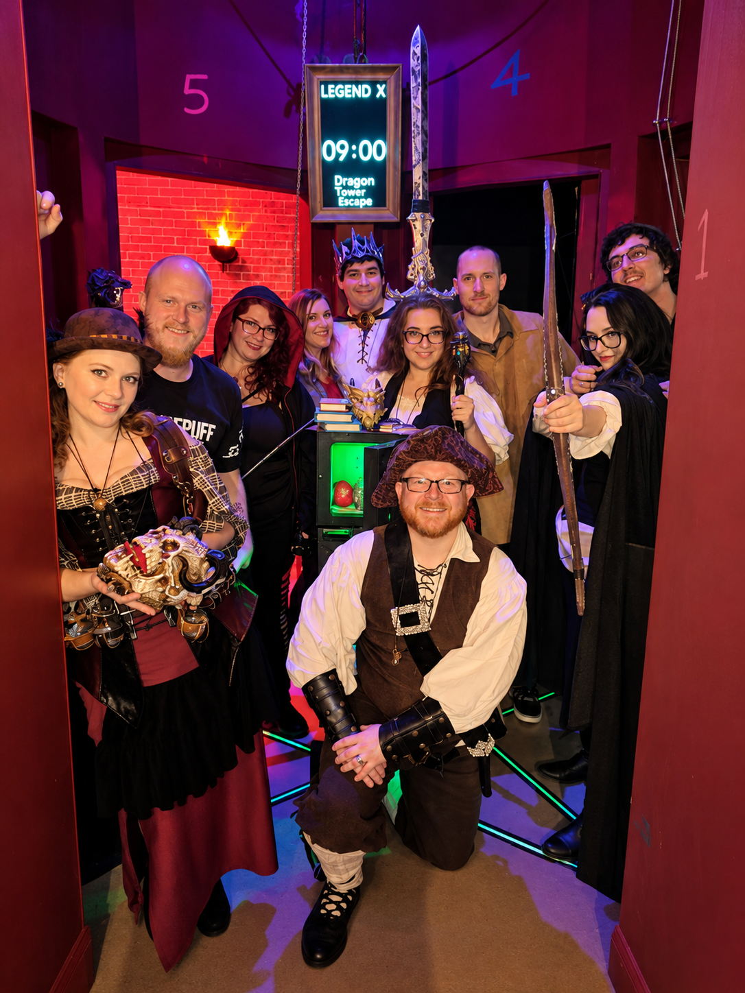 A Dragon Tower team celebrating in pirate and hero costumes